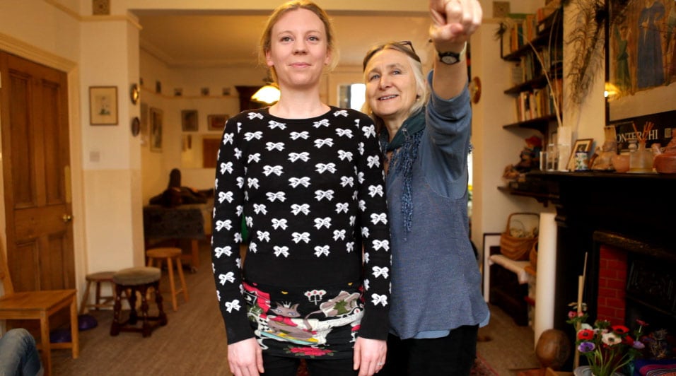 Penny O'Connor teaching Alexander Technique - she is pointing upwards, gently encouraging her pupil to lengthen and move with ease.